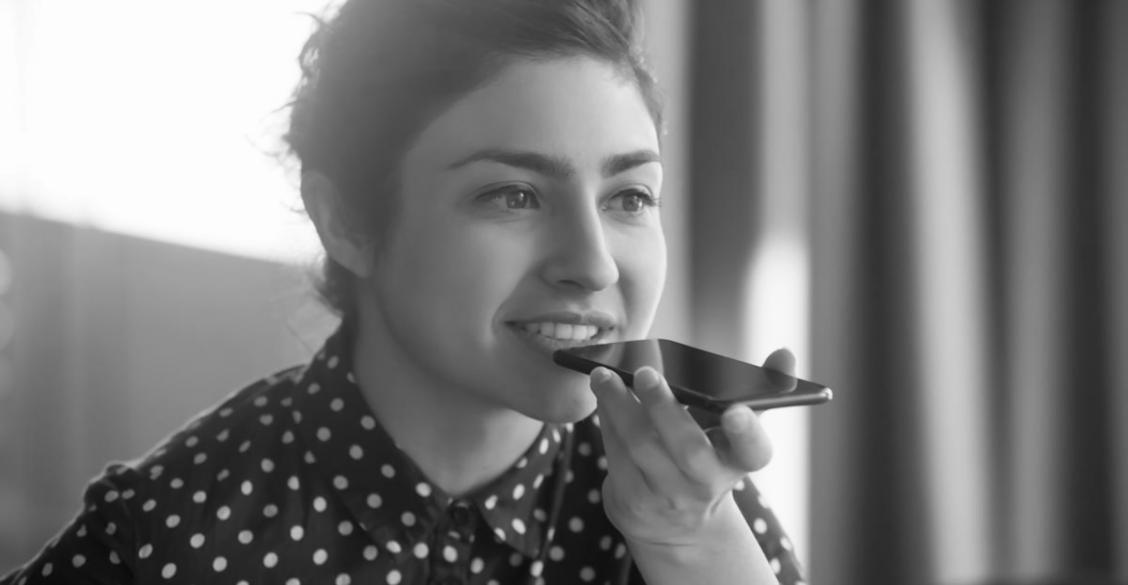 Student photographer examining camera composition settings during outdoor photography session